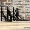 imageEkena Millwork BKTM01X10X12SDA 1 2quot W x 10quot D x 12quot H Damon Wrought Iron Bracket Single Center BraceAntiqued Warm Silver