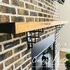 imageEkena Millwork BKTM01X10X12STN 1 2 W x 10 D x 12 H Tristan Wrought Iron Bracket Single Center BraceAntiqued Brass