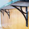 imageEkena Millwork BKTM01X10X12SVE 1 2 W x 10 D x 12 H Versailles Wrought Iron Bracket Single Center BracePowder Coated Black